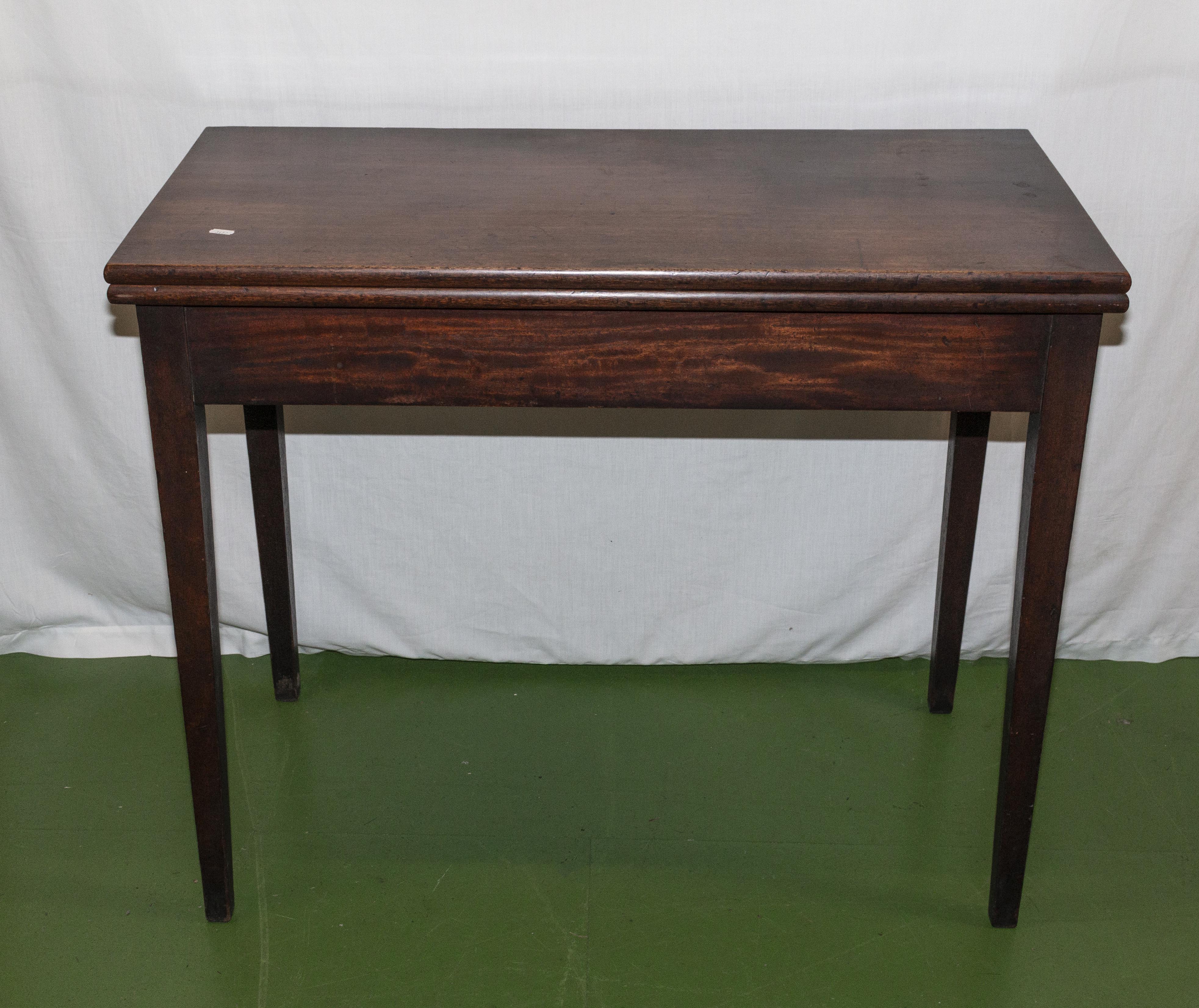 An Edwardian mahogany turn over tea table