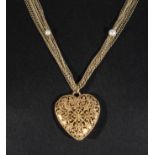 A Chanel metal and pearl chain necklace and heart shaped pierced pendant in original box