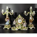 A Victorian Schierholz porcelain clock garniture, clock measures 30cm high, candelabra 44.5cm high