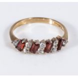 A 9ct gold ring set with eight diamonds and four garnets