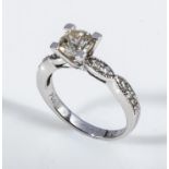 An 18ct white gold diamond solitaire ring with diamond shoulders, 1 carat, size L