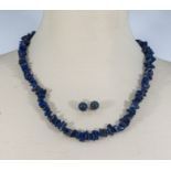 A blue lapis lazuli strung necklace and a pair of earrings