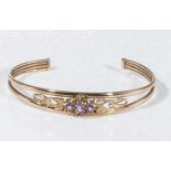 A 9ct gold bangle set with amethyst