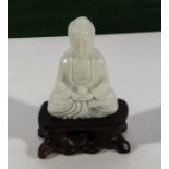 A white jade Buddha and stand