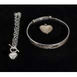 A silver bangle, bracelet and a locket
