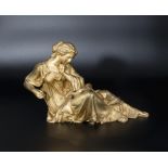 An ormolu reclining lady