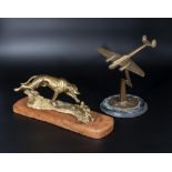 A brass greyhound and rabbit figure group together with a brass model of a plane