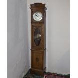 An Edwardian free standing clock in oak case, working condition.