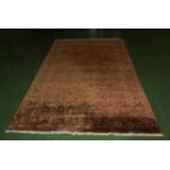 A large brick ground Tabriz carpet 208cm x 309cm