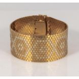 An 18ct gold reversible cuff bracelet, purchased in Switzerland makers mark S.M. weight 77gms