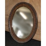An oval walnut mirror.