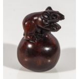 Hand carved hardwood netsuke of a rat on an apple