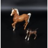 A Beswick palomino pony and a foal