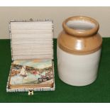 A stoneware jar and a box of vintage table mats