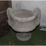 A re-constituted stone garden urn