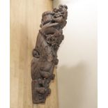 A carved Indian teak corbel bracket, late 19th early 20th century, featuring a serpents head wearing