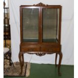 A mid 20th century display cabinet in walnut.