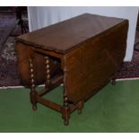 An oak drop leaf table with barley sugar supports and legs