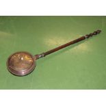 A copper bed warmer pan