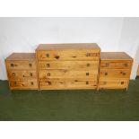 An oak chest of four drawers and two matching bedside drawers