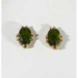 A pair of 9ct gold earrings set with peridot