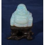 A moonstone Buddha and stand