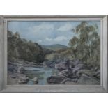 A small framed watercolour of a river scene