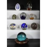 Nine glass paperweights