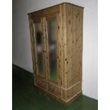 A pine double wardrobe with mirror doors