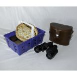 A pair of binoculars and a basket of assorted items