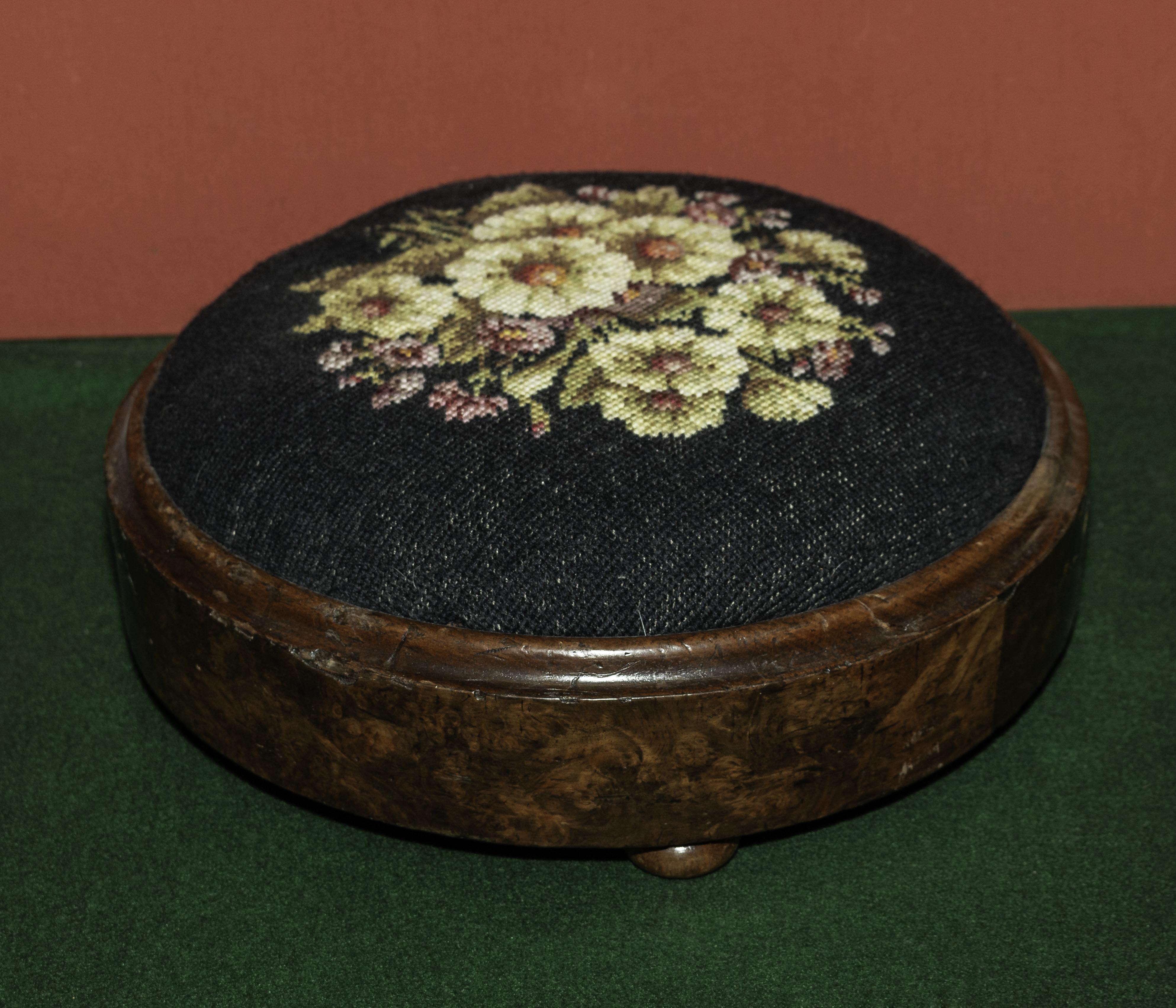 A round upholstered foot stool