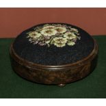 A round upholstered foot stool