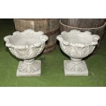 A pair of reconstituted stone garden urns