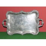 A Sheffield plated tray with shaped floral border and handles, Royal crest to the centre with crown.