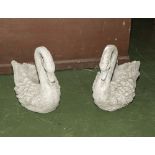 A pair of reconstituted stone garden swans