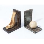 A pair of Art Deco marble and alabaster bookends in the form of a Lacrosse ball and racket