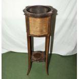 An inlaid mahogany plant stand