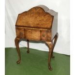 A shaped walnut bureau on Queen Ann legs.