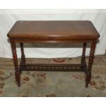 A late Victorian mahogany turn over top card table