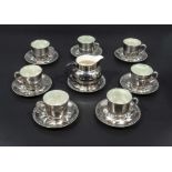 A silver lustre pottery set 6 cups and saucers and a milk jug