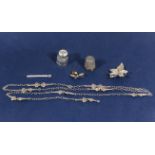 Two silver thimbles, three silver brooches and a decorative chain