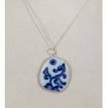 A Ming dynasty blue and white porcelain shard mounted in Chinese silver with sterling silver chain.