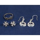 Two pairs of silver earrings and a bow ring