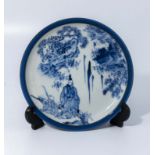 Small Chinese blue and white dish decorated with a sage and attendant amongst foliage, fully