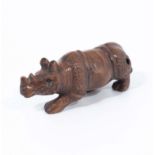 A hand carved hardwood netsuke of Sumatran rhinoceros