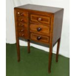 An inlaid mahogany chest on legs.