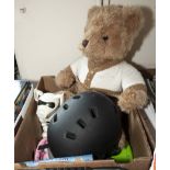 A bike helmet, teddy bear and other toys