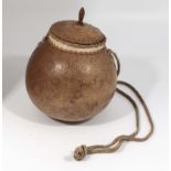 A vintage African water carrier gourd