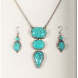 A silver three drop pendant set with turquoise and matching earrings