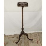 A tall 20th century plant stand with fretted top.